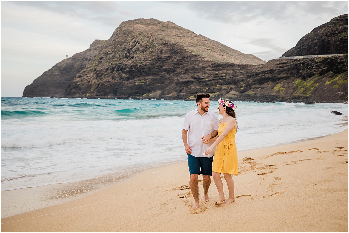 Newlywed couple on the beach during their honeymoon in hawaii
