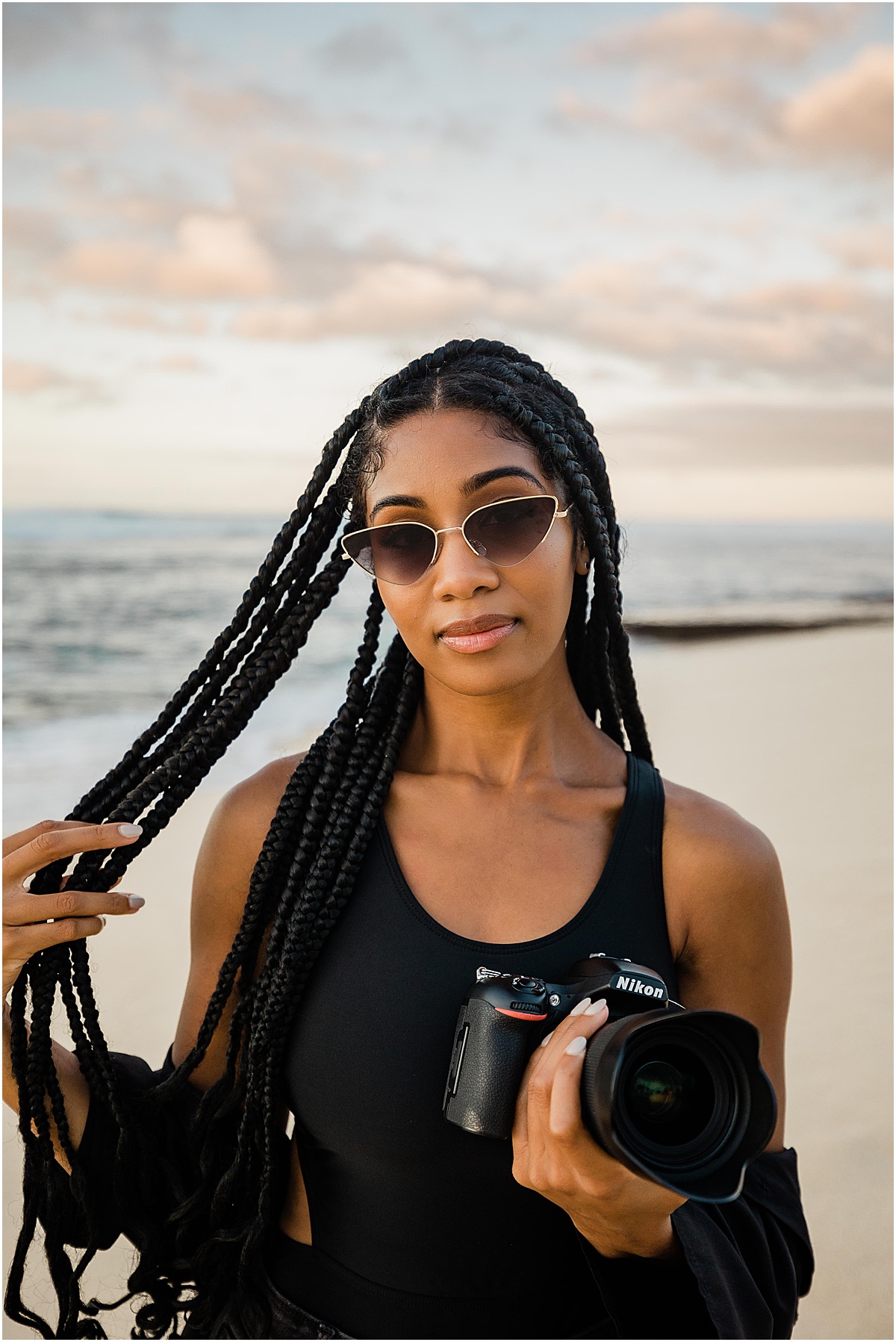 girl with camera at the beach by orange county branding photographer