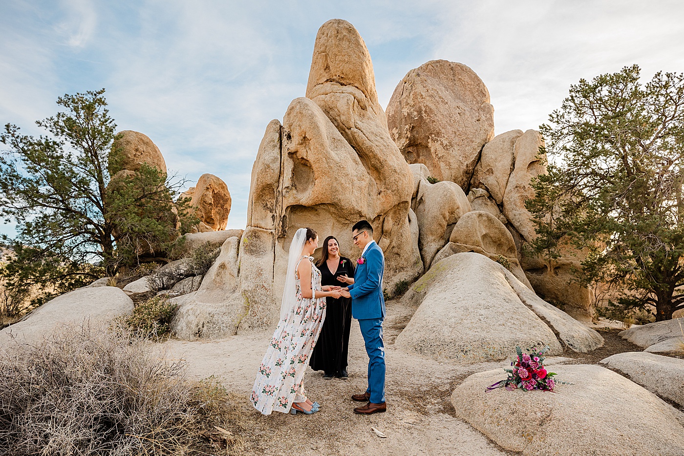 Joshua tree elopement ceremony with bride, groom and wedding officiant.
