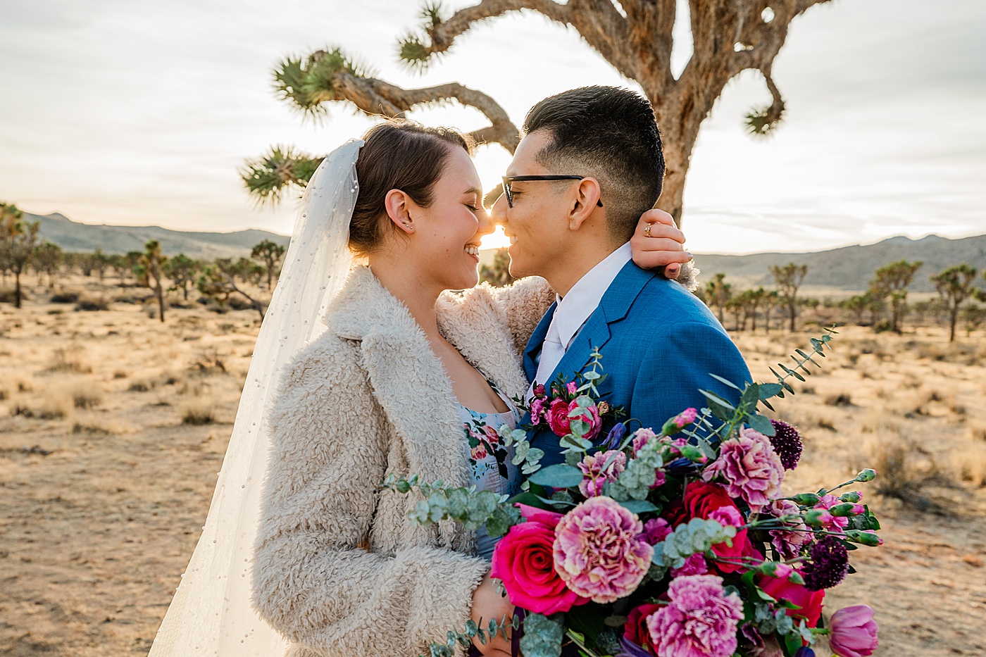 Joshua tree elopement at sunset. Bride and groom kissing.