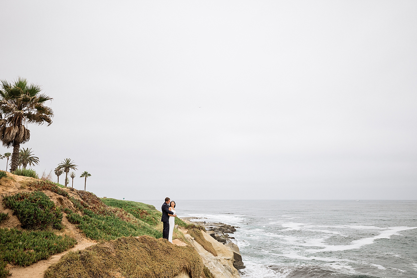 Bride and groom cliffside in San Diego elopement.