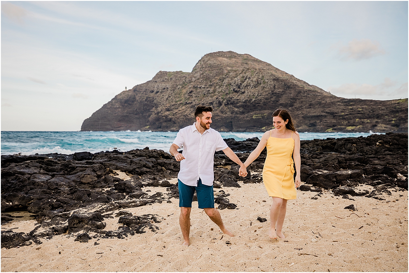 Newlywed couple on the beach during their honeymoon in hawaii