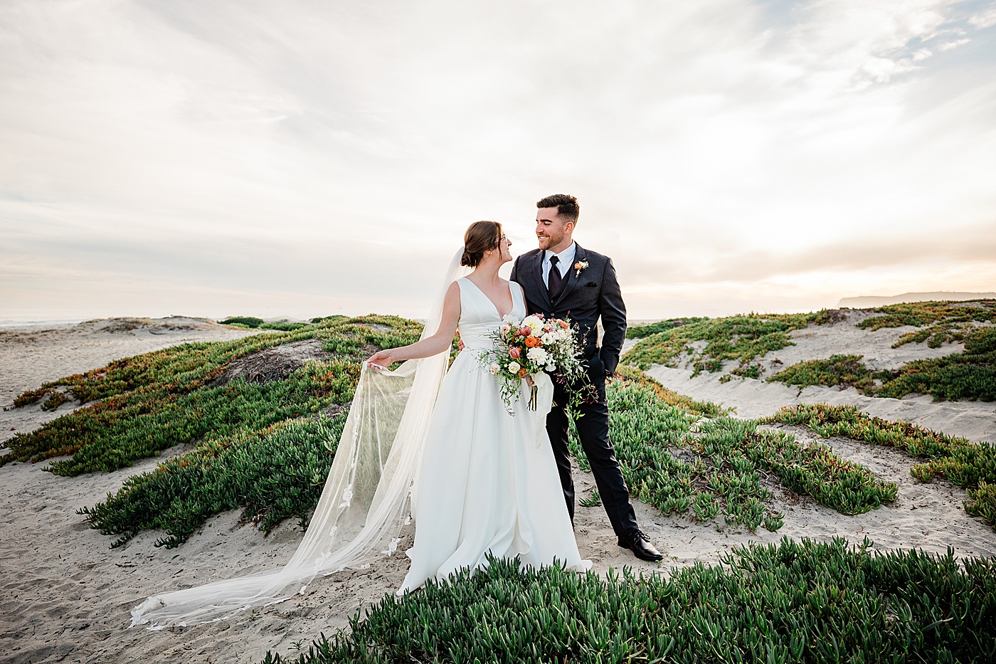 Coronado Beach elopement at sunset. A bride and groom at the sand dunes.